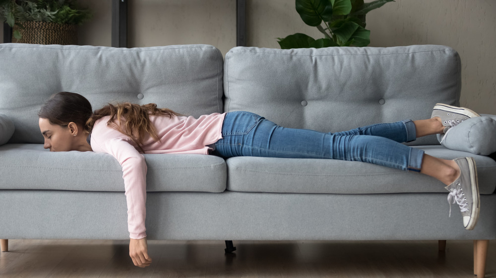 Sick woman lying on couch