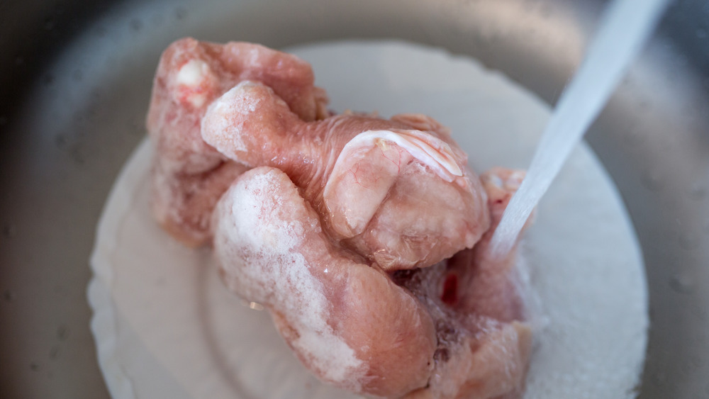 raw meat being washed