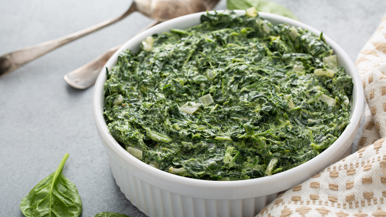 creamed spinach in white casserole dish