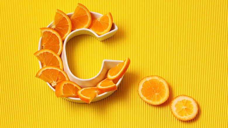 oranges in shape of the letter C on orange background