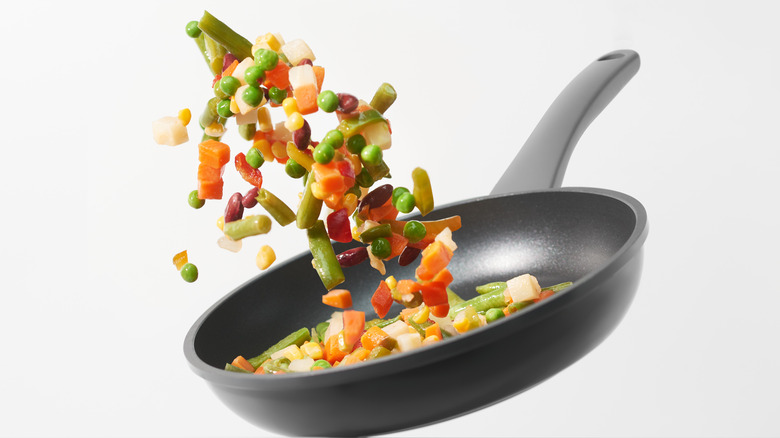 flipping vegetables in pan 