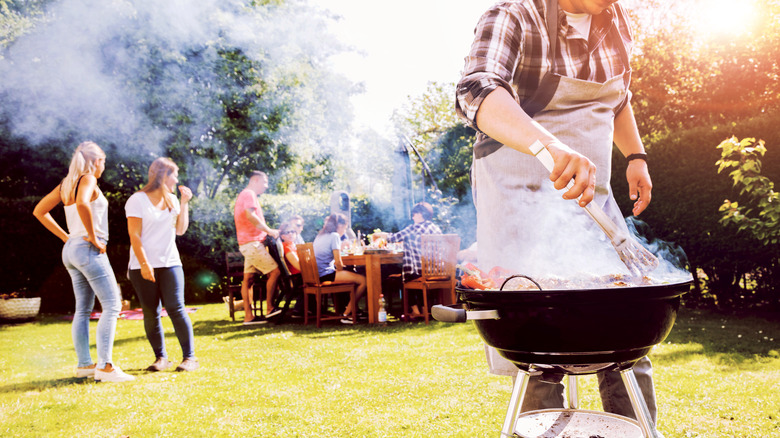 Man cooking on backyard grill