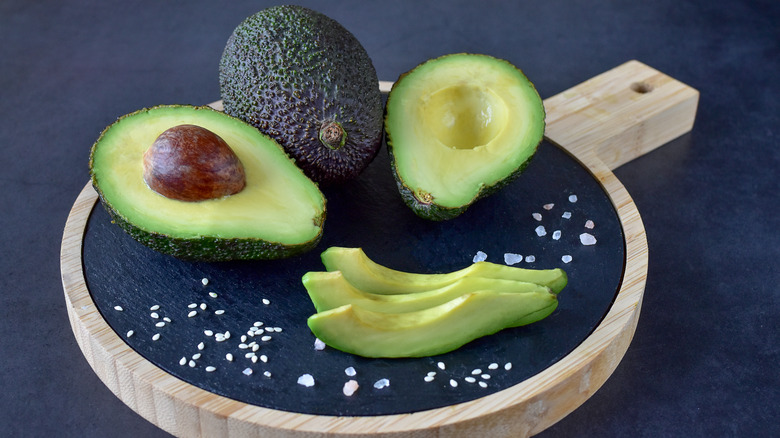 avocado on board with coarse salt