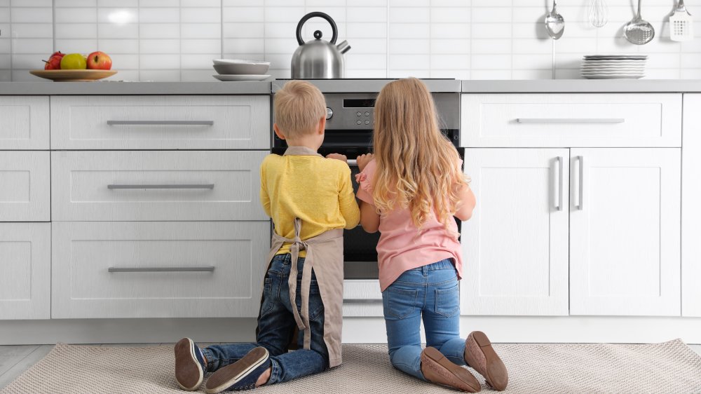 Kids watching an oven