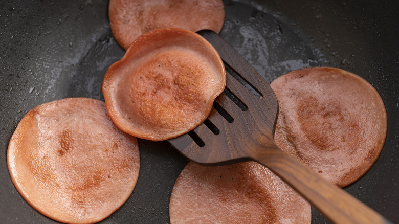 Fried bologna slices in pan