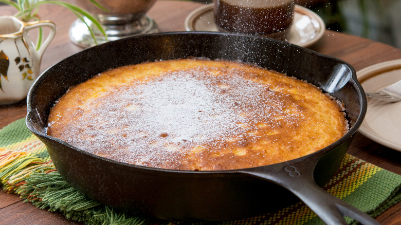 Sugar being sprinkled on top of cornbread