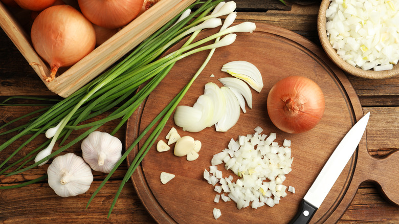 onions and green onions, some chopped on cutting board