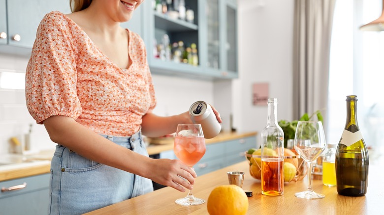 woman creating cocktail 