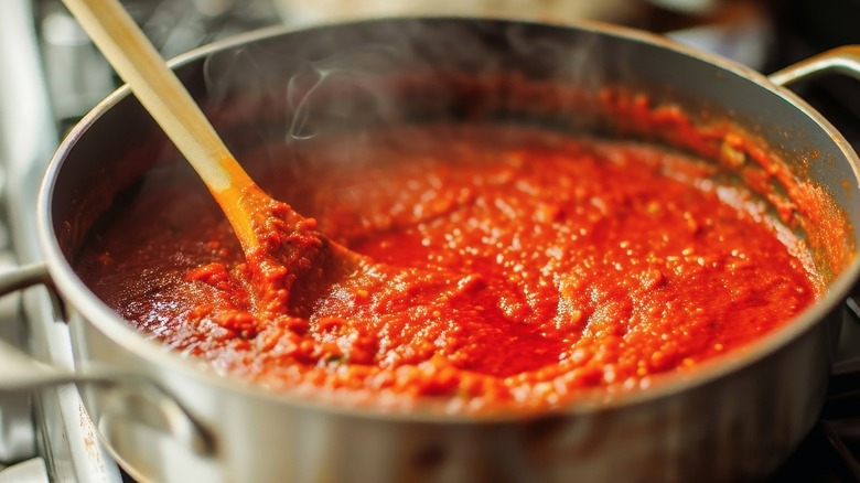 simmering tomato sauce on stove