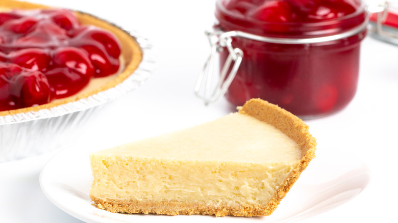 cheesecake with berries in background