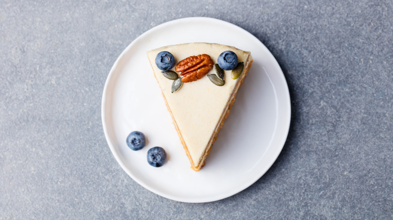 slice of cheesecake on a plate with berries