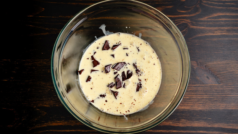 Cream and chocolate for making ganache in glass bowl