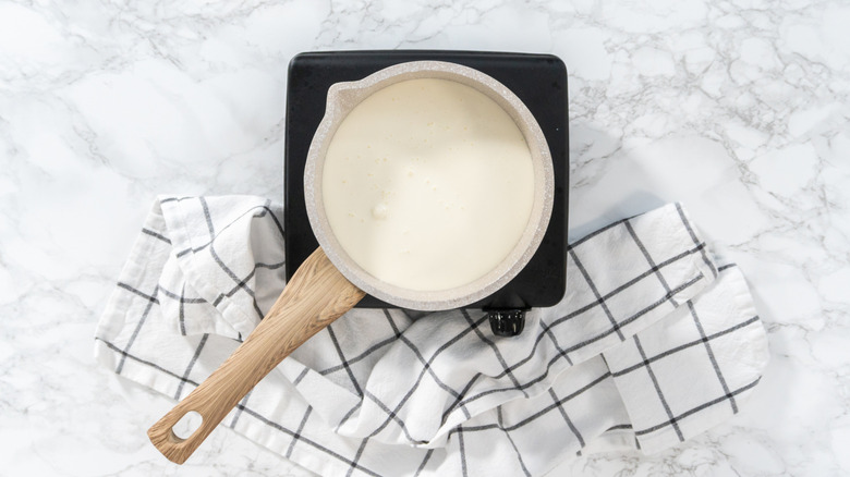 Heating cream for ganache on marble surface