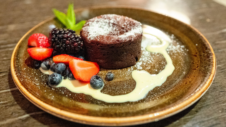 Lava cake on a plate with garnishes