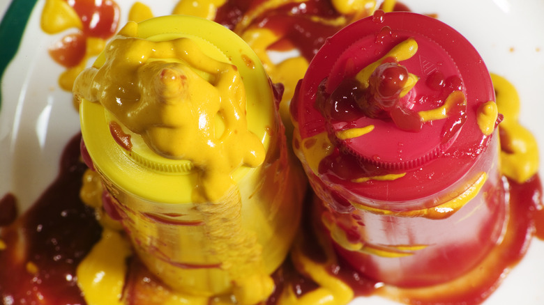 Messy ketchup and mustard bottles