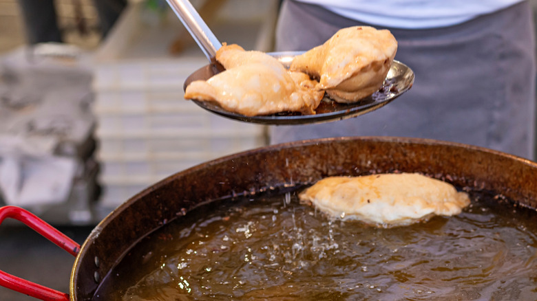 Empanadas being deep fried