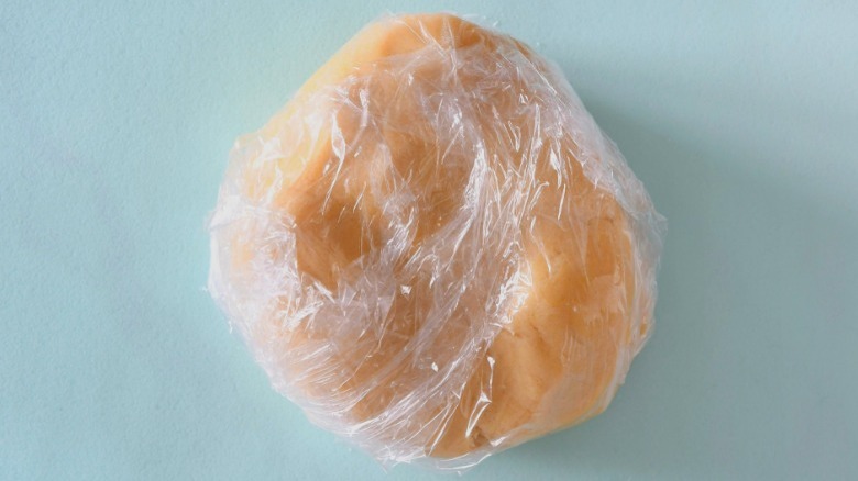 dough ball wrapped in plastic