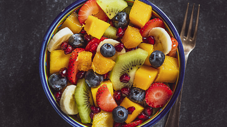 bowl of fruit salad on black counter