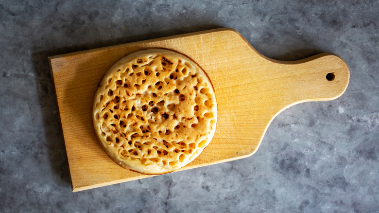 Crumpet on a wooden board