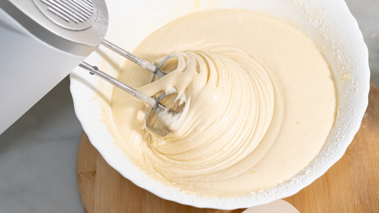 Mixing batter in a white bowl