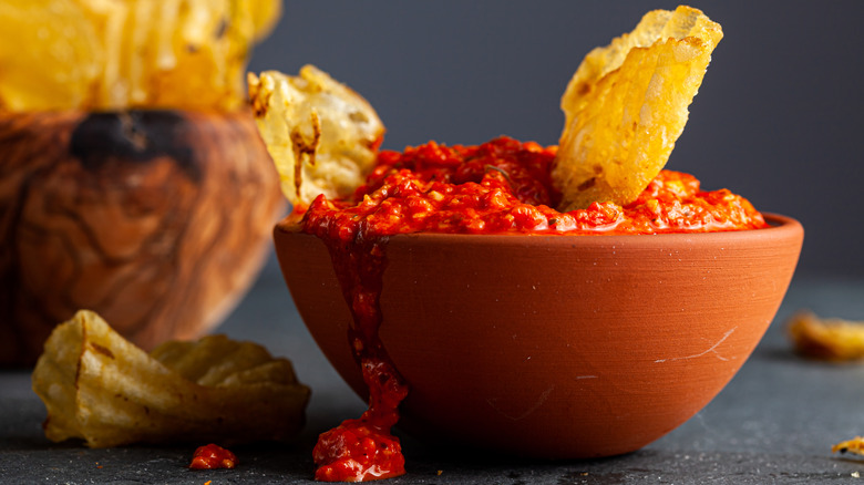 bowl overspilling with salsa and chips