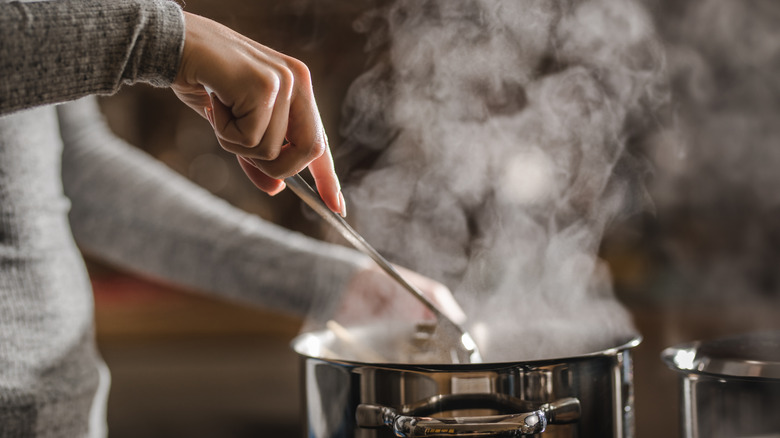 Person stirring a pot