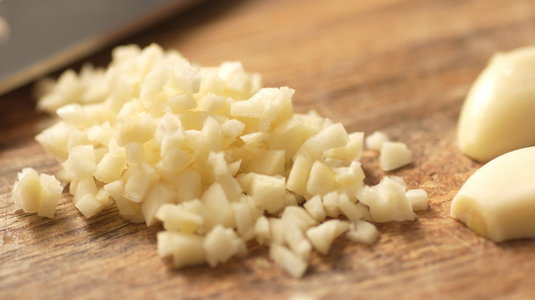 Chopped fresh garlic on a wooden board