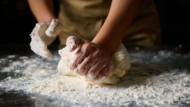 Hands working dough on the counter