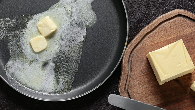 Melting butter in pan next to cold butter on board