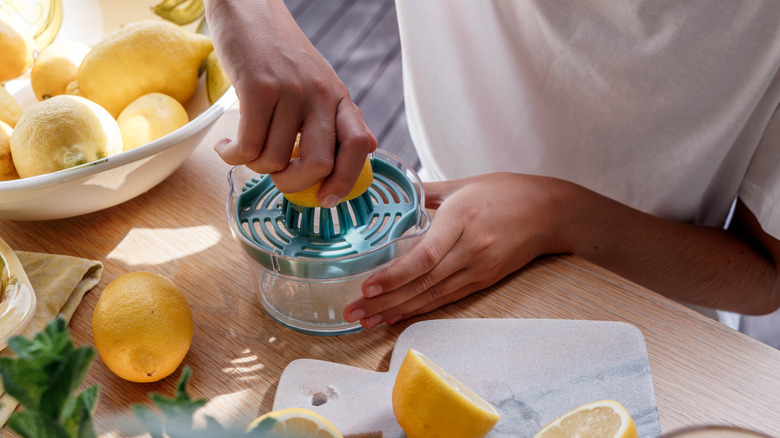 Hands juicing lemons