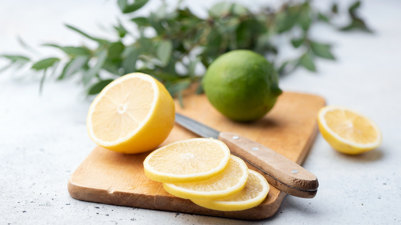 Lemon and lime on cutting board