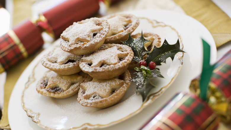 Plate of mince pies on table with Christmas crackers