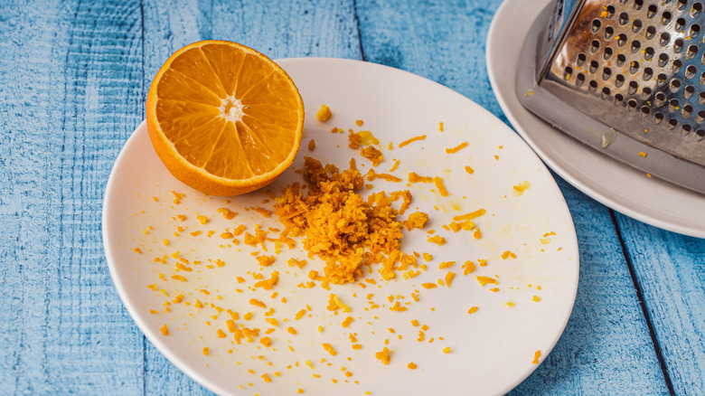 Orange and orange zest on plate