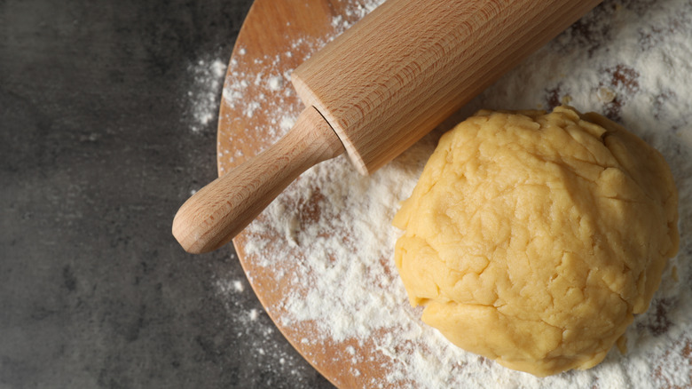 Pastry dough and rolling pin on counter