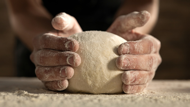 Hands holding pastry dough