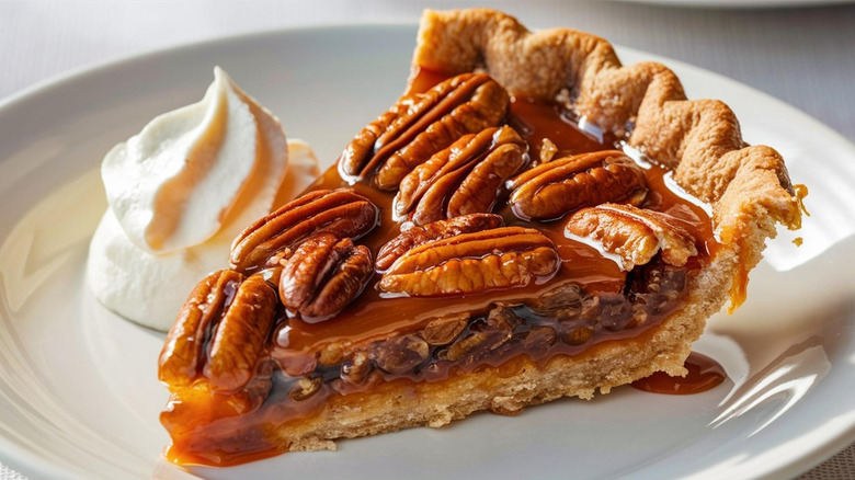 Slice of pecan pie with whipped cream