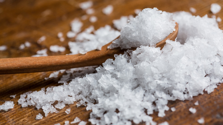 Sea salt flakes with wooden spoon