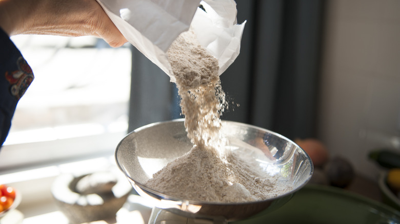 Person weighing flour