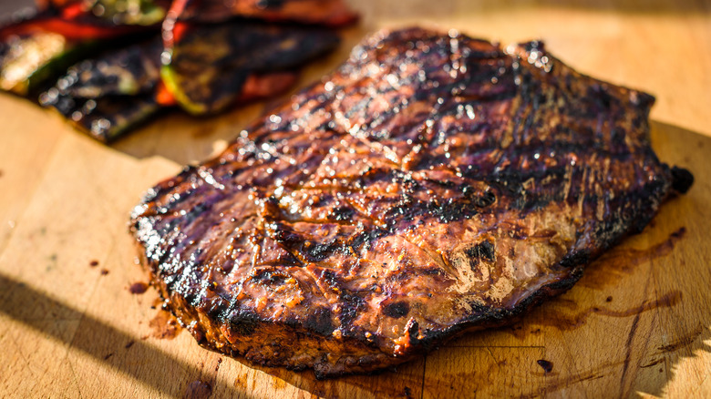 Beef steak resting on board