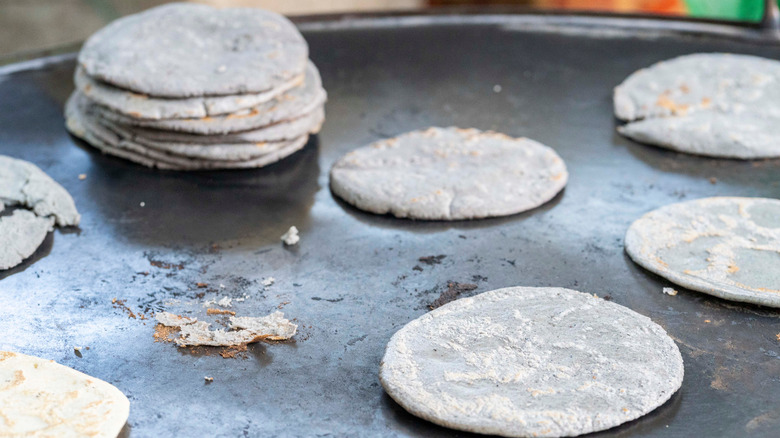 blue corn tortillas on griddle