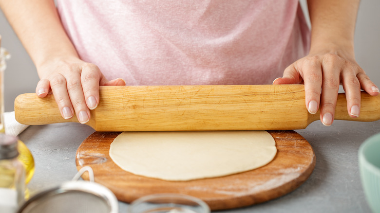 woman rolling tortilla dough