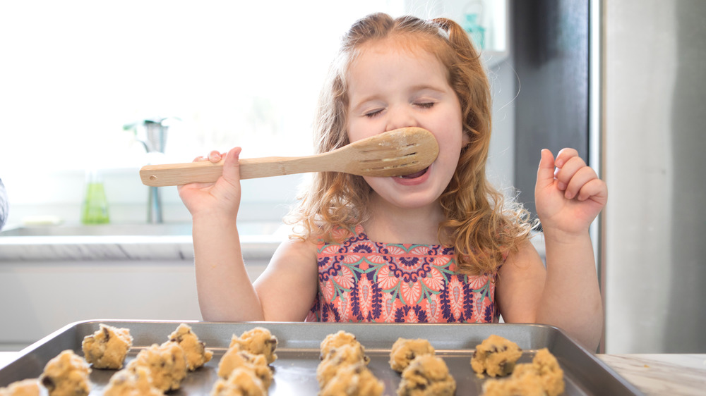 girl eating raw cookie dough