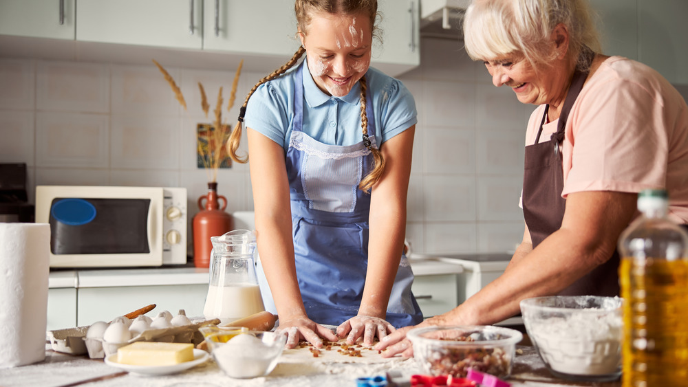 Girl and grandma making raw cookie dough