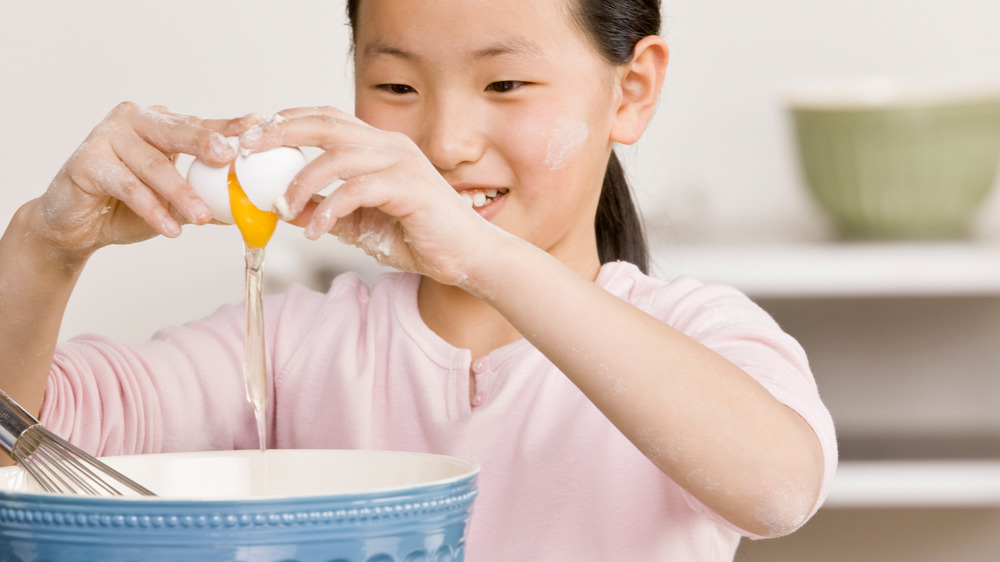 Cracking eggs for cookie dough