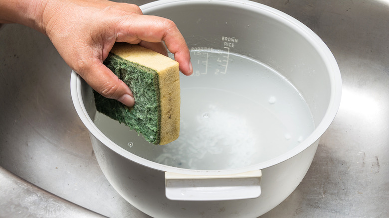 Hand cleaning rice cooker with sponge