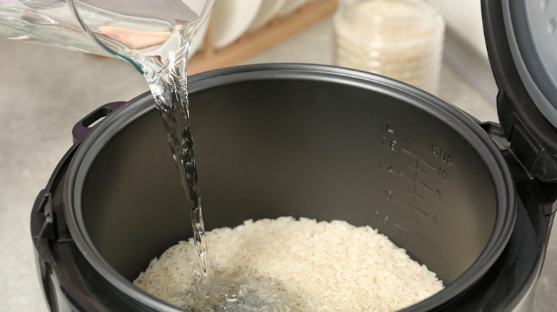 Water pouring into rice cooker