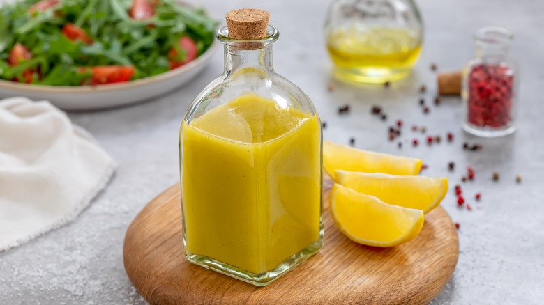 Bottle of salad dressing and lemon wedges