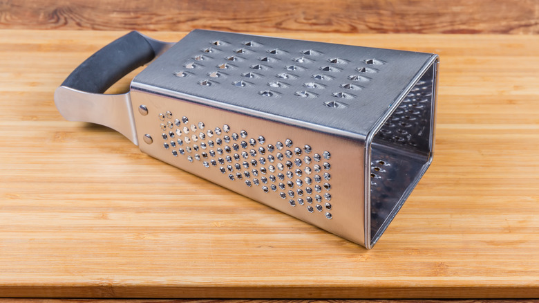 box grater on cutting board on its side