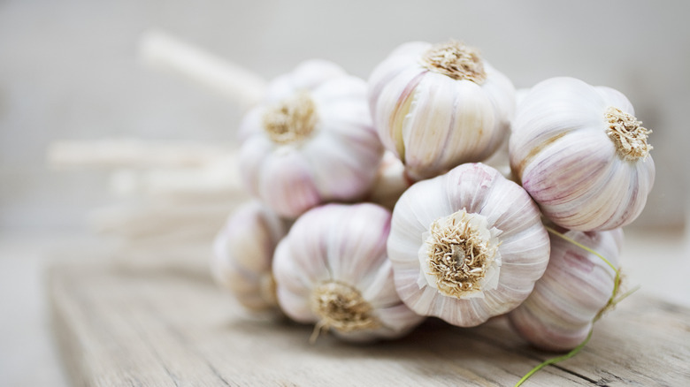 bulbs of garlic on cutting board