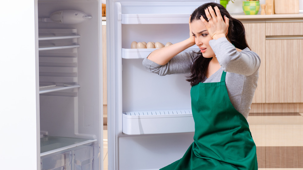 woman cleaning her refrigerator